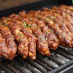 Close-up of smoked meats including brisket, ribs, and chicken on a wooden board, surrounded by spices, BBQ sauce, and fresh garnishes, highlighting bold BBQ flavors