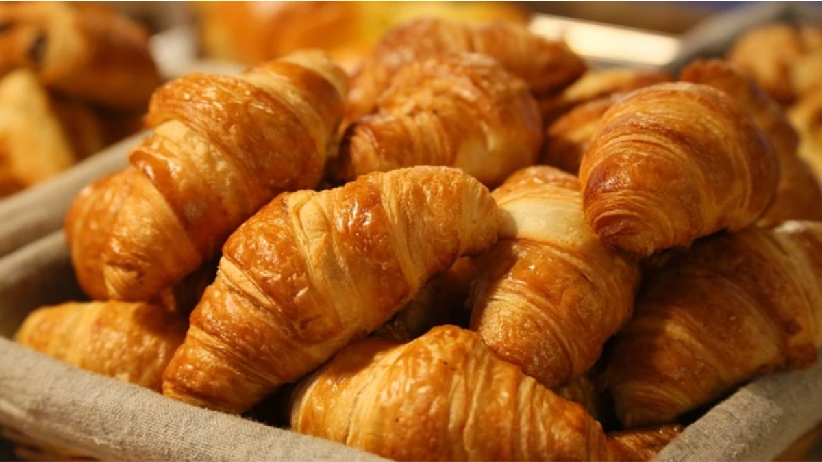 Homemade Swiss Gipfeli crescents with a golden-brown crust.